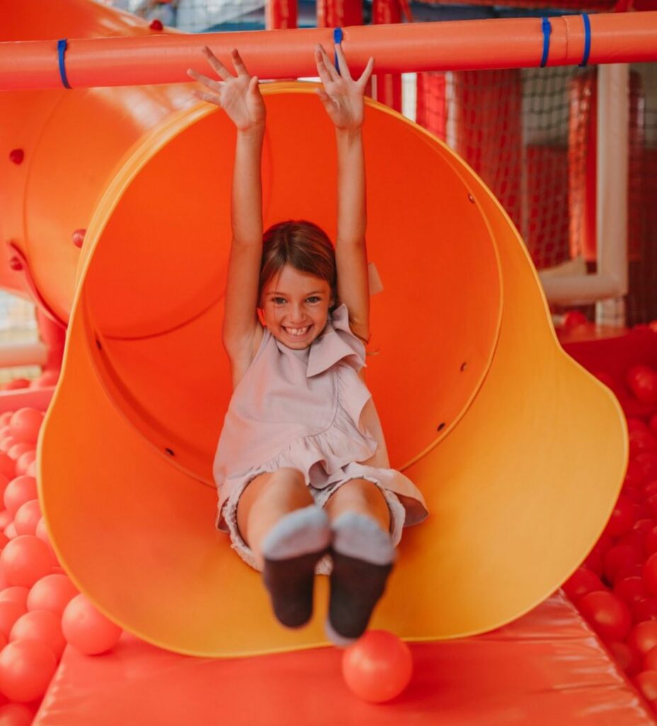 Niña sonriendo en tobogán